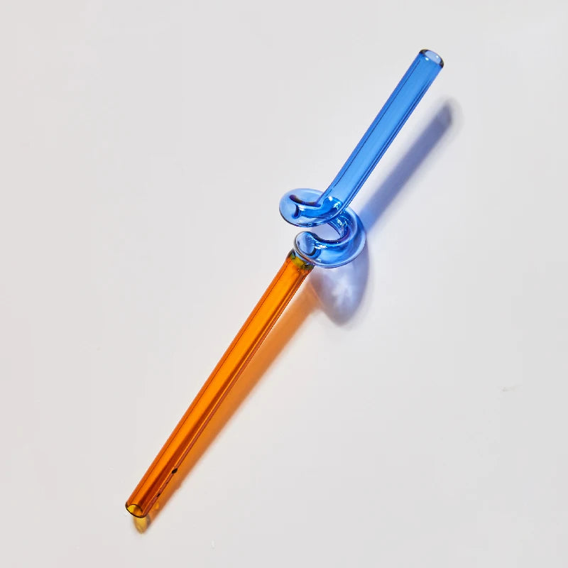 Glass smoking device with blue and orange components on a light gray background