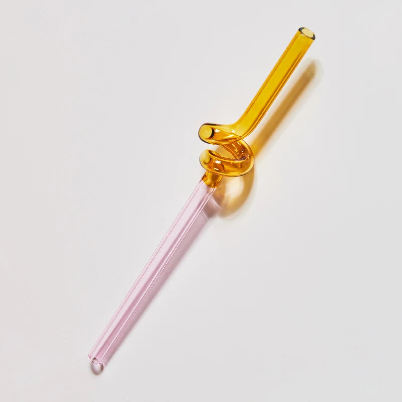 Glass pipe with pink base and gold top on a white background