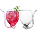 Two glass drinkware with straws, one filled with a red cocktail and ice, on a white background.