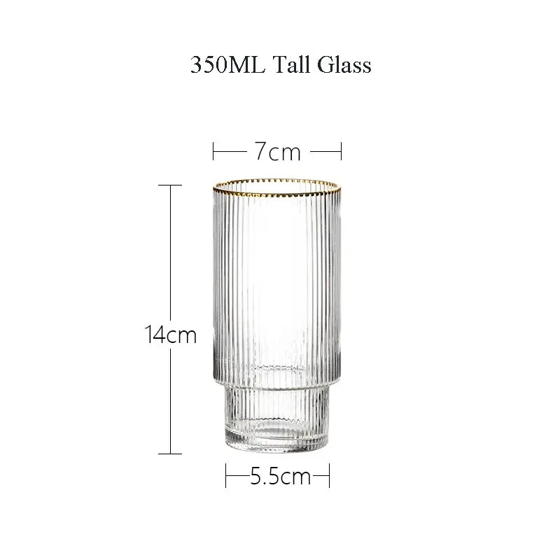 Clear glass tall glass with gold rim and measurements on a white background