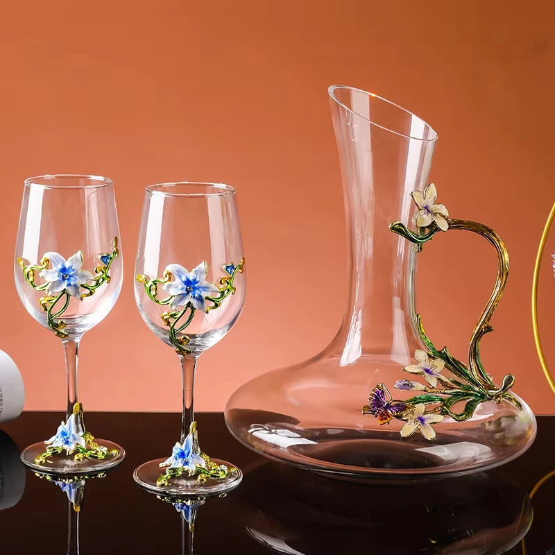 Set of wine glasses and a decanter with floral designs on an orange background