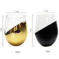 Two wine glasses with gold and black design, showing measurements and volume.
