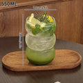 Glass with lemon and mint on a wooden coaster, with measurements indicated.