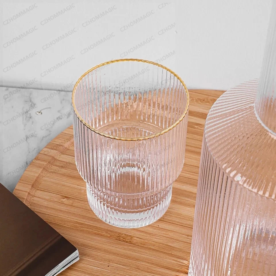 Clear glass with gold rim on a wooden surface