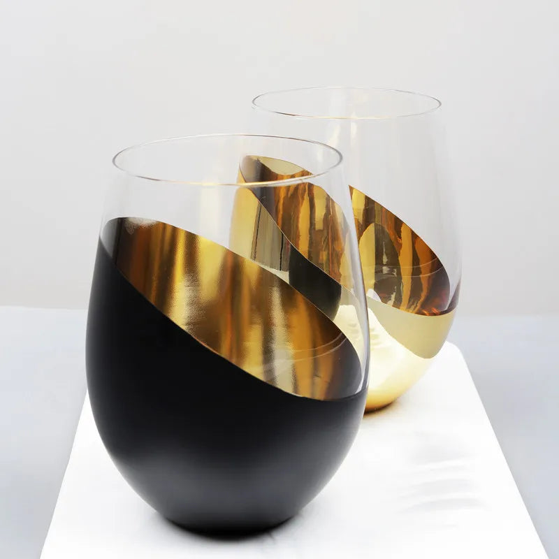 Modern glass vase with black and gold design on a white surface
