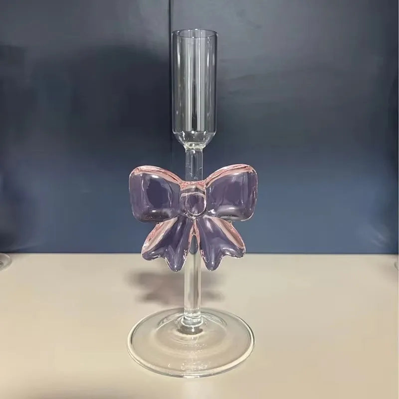 Clear glass with a pink bow on a dark background