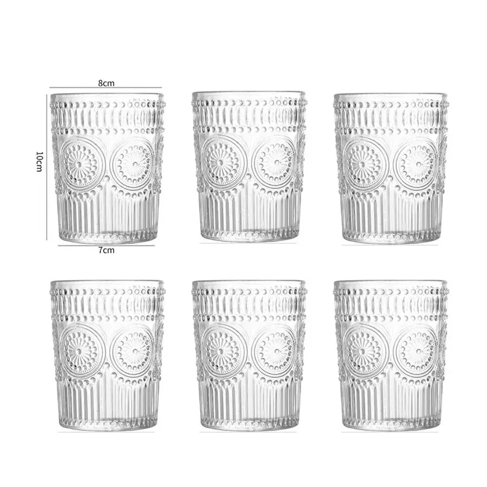 Set of six clear glass tumblers with decorative patterns and measurements on a white background