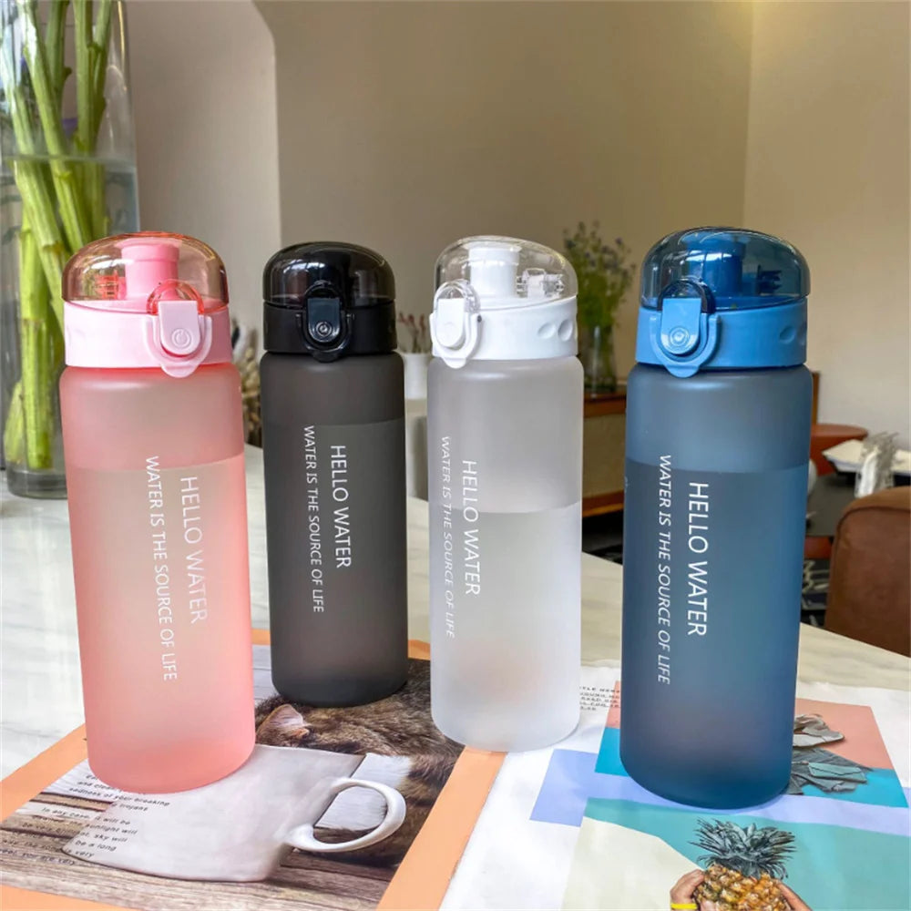 Four 'HELLO WATER' branded water bottles in different colors on a table.