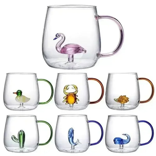 Set of glass mugs with animal figurines on a white background