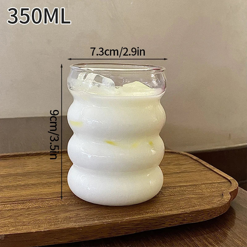 White textured glass container with measurements on a wooden surface